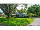 Charming single-story home with a beautifully landscaped front yard and mature trees at 1202 Marshall Ct, Eustis, FL 32726