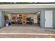 Spacious garage featuring ample storage, tools, and equipment organization at 1202 Marshall Ct, Eustis, FL 32726