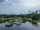 Picturesque lake view featuring a dock, boats, and serene waterfront homes at 1202 Marshall Ct, Eustis, FL 32726