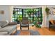Bright living room featuring a large bay window with views of the lush yard at 1202 Marshall Ct, Eustis, FL 32726