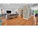 Bright living room featuring hardwood floors, comfortable seating, and stylish decor with easy access to the backyard at 1202 Marshall Ct, Eustis, FL 32726