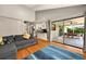 Bright living room with sliding glass doors to the screened patio and a view of the kitchen at 1202 Marshall Ct, Eustis, FL 32726