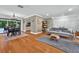 Spacious living room flows into the dining area, featuring hardwood floors and abundant natural light at 1202 Marshall Ct, Eustis, FL 32726