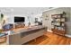 Open-concept living room with hardwood floors and built-in shelving at 1202 Marshall Ct, Eustis, FL 32726