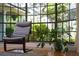 Sunroom featuring floor to ceiling windows, hardwood floors, chair, and plant at 1202 Marshall Ct, Eustis, FL 32726