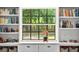 Interior window with a view of lush landscaping and built-in shelving at 1202 Marshall Ct, Eustis, FL 32726