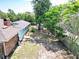 Aerial view of the home showing the roof, pool, shed, fence and surrounding trees at 1233 Gladstone Dr, Deltona, FL 32725