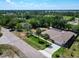 A sunny aerial view of a house on a street with a lush, green neighborhood at 1233 Gladstone Dr, Deltona, FL 32725