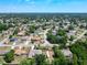 This aerial shows the property surrounded by a lush, green neighborhood on a sunny day at 1233 Gladstone Dr, Deltona, FL 32725