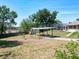 An aerial view shows the home, and highlights a backyard with a pergola and screened-in pool area at 1233 Gladstone Dr, Deltona, FL 32725