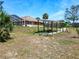 Aerial showcases a home with a screened-in pool and outdoor pergola, blending comfort and outdoor living at 1233 Gladstone Dr, Deltona, FL 32725