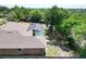 Aerial view of the home showing the roof, pool, shed, carport and surrounding trees at 1233 Gladstone Dr, Deltona, FL 32725