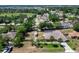 This aerial view shows the layout of the house, shed, carport and screened pool within the fenced lot at 1233 Gladstone Dr, Deltona, FL 32725