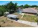 A charming single-Gathering home with a screened pool, carport, storage shed, and a spacious backyard at 1233 Gladstone Dr, Deltona, FL 32725