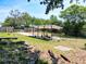 A shaded pergola is a backyard focal point, framed by a lush landscape and a wooden fence at 1233 Gladstone Dr, Deltona, FL 32725