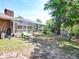Elevated view of screened pool and the back of the home with its brick facade and numerous windows at 1233 Gladstone Dr, Deltona, FL 32725