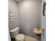 Small bathroom with coastal decor, featuring a compact sink and toilet at 1233 Gladstone Dr, Deltona, FL 32725