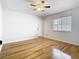 Bedroom featuring hardwood floors, a ceiling fan, and natural light from the large window at 1233 Gladstone Dr, Deltona, FL 32725