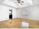 Spacious bedroom with wood floors, a tray ceiling, and lots of natural light from a window at 1233 Gladstone Dr, Deltona, FL 32725