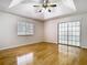 Bright bedroom with gleaming wood floors and a decorative sliding glass door to the patio at 1233 Gladstone Dr, Deltona, FL 32725