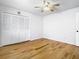 Bright bedroom featuring hardwood floors, a ceiling fan, and closet with louvered doors at 1233 Gladstone Dr, Deltona, FL 32725