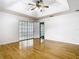 Bright bedroom with gleaming wood floors, a decorative sliding glass door, and door to bath at 1233 Gladstone Dr, Deltona, FL 32725