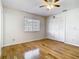 Bedroom with wood floors, large window, ceiling fan and closet for ample storage at 1233 Gladstone Dr, Deltona, FL 32725