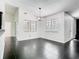 Open dining area boasts modern lighting, black tile flooring, and views of the windows at 1233 Gladstone Dr, Deltona, FL 32725