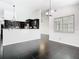 Dining space boasts black tile flooring, a modern light fixture, and a view into the updated kitchen at 1233 Gladstone Dr, Deltona, FL 32725
