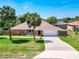 Beautiful single-story home with a large driveway, two-car garage, and well-kept lawn at 1233 Gladstone Dr, Deltona, FL 32725