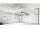 Spacious two car garage with white walls and ceiling and a garage door opener at 1233 Gladstone Dr, Deltona, FL 32725