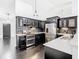 Modern kitchen featuring black cabinets, stainless steel appliances, and a mosaic backsplash at 1233 Gladstone Dr, Deltona, FL 32725