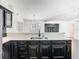 Open-concept kitchen featuring stainless steel sink, black cabinetry and ample counter space at 1233 Gladstone Dr, Deltona, FL 32725