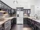 Bright kitchen with sleek stainless steel appliances, dark cabinets, and white countertops at 1233 Gladstone Dr, Deltona, FL 32725