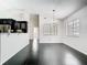 Bright, open living space with black tile floors and a modern chandelier at 1233 Gladstone Dr, Deltona, FL 32725