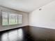 Open living room featuring large windows with blinds, dark tile flooring, and neutral walls at 1233 Gladstone Dr, Deltona, FL 32725