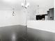 Open living space featuring a modern chandelier, black tile flooring, and a view to the kitchen at 1233 Gladstone Dr, Deltona, FL 32725