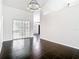 Spacious living room showcases modern lighting fixtures, black tile flooring, and large glass doors to the outside at 1233 Gladstone Dr, Deltona, FL 32725