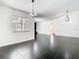 Spacious living area featuring modern chandeliers, black tile flooring, and large window at 1233 Gladstone Dr, Deltona, FL 32725