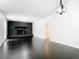 Open living room with black brick fireplace, neutral walls and sleek tile flooring at 1233 Gladstone Dr, Deltona, FL 32725