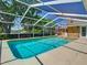 Enclosed pool with a screened enclosure, concrete surround and a brick home visible in the background at 1233 Gladstone Dr, Deltona, FL 32725