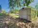 Backyard shed with grass and bare ground surrounding, partial views of home and covered parking area at 1233 Gladstone Dr, Deltona, FL 32725
