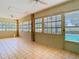 Inviting sunroom filled with natural light from large windows and tiled floors at 1233 Gladstone Dr, Deltona, FL 32725