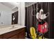 Charming bathroom with Mickey Mouse-themed shower curtain at 12335 Cruxbury Dr, Windermere, FL 34786