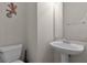 Minimalist powder room with pedestal sink and modern decor at 12335 Cruxbury Dr, Windermere, FL 34786
