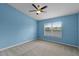 Bright bedroom featuring a ceiling fan and a large window at 12335 Cruxbury Dr, Windermere, FL 34786