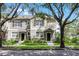 Charming townhome with well-manicured lawn and inviting entrance framed by mature trees on a sunny day at 12335 Cruxbury Dr, Windermere, FL 34786