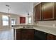 Modern kitchen featuring granite countertops and stylish dark cabinets in an open-concept design for easy entertaining at 12335 Cruxbury Dr, Windermere, FL 34786