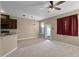 Relaxing living space featuring a ceiling fan, tile flooring, and access to the outdoors with neutral paint at 12335 Cruxbury Dr, Windermere, FL 34786