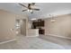 Inviting living space seamlessly connects to kitchen, enhancing open feel with neutral paint, and modern ceiling fan at 12335 Cruxbury Dr, Windermere, FL 34786